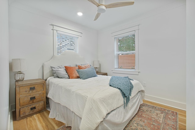 bedroom featuring hardwood / wood-style floors, ceiling fan, and ornamental molding