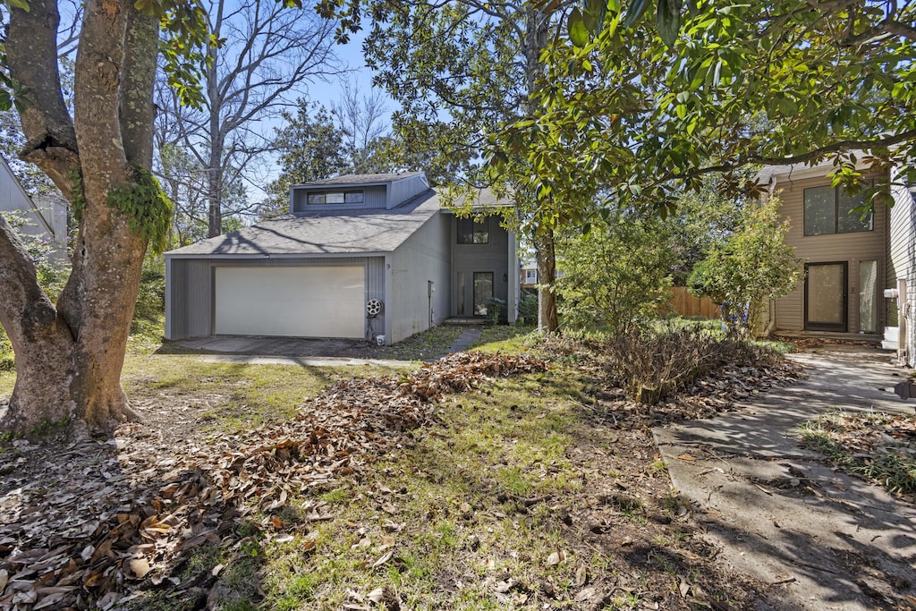 back of property with a shingled roof