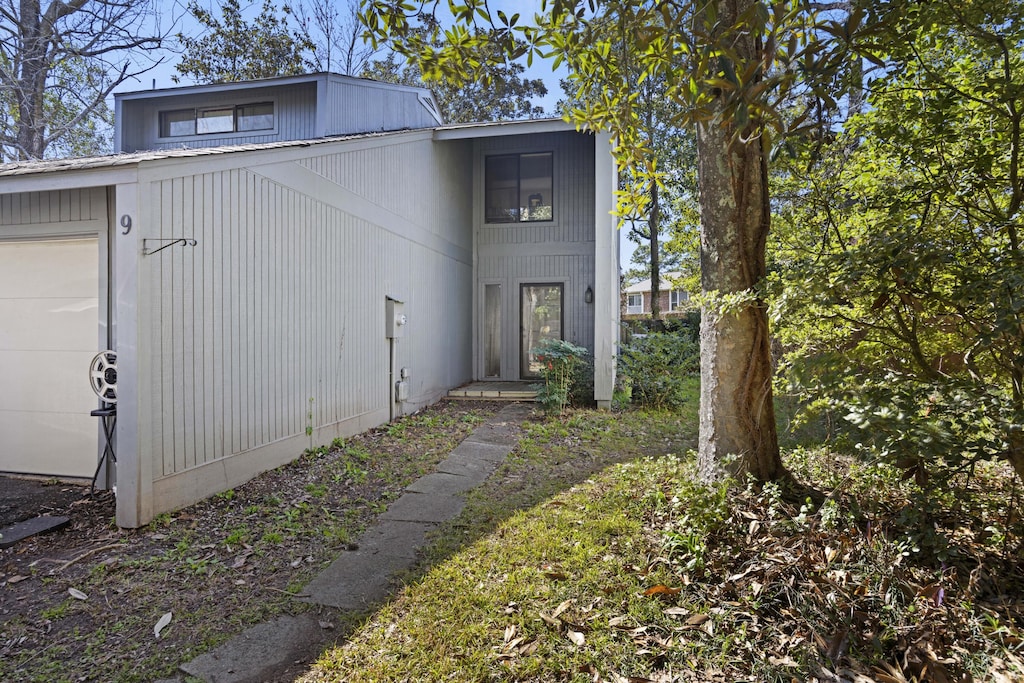 view of side of home featuring an attached garage