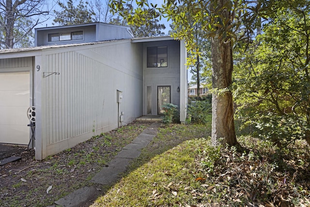 view of side of home featuring an attached garage