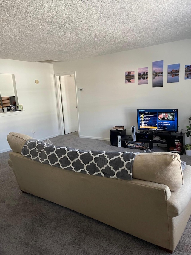 carpeted living room featuring a textured ceiling