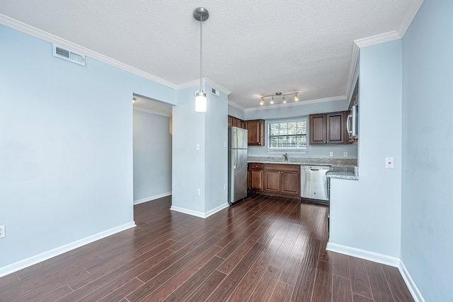 kitchen with stainless steel appliances, dark hardwood / wood-style floors, a textured ceiling, crown molding, and pendant lighting