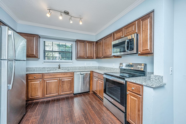 kitchen featuring a textured ceiling, stainless steel appliances, dark hardwood / wood-style floors, and crown molding