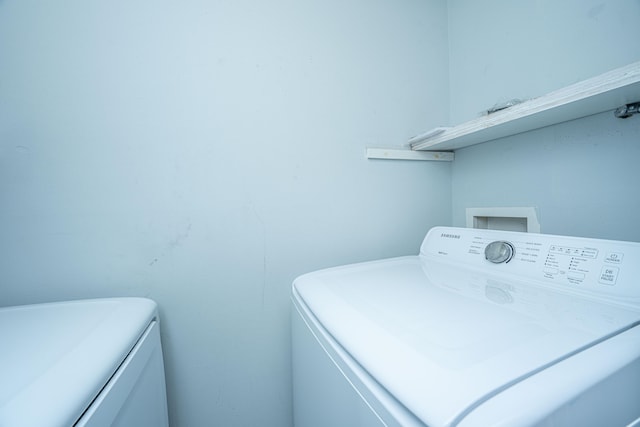 clothes washing area with washer / dryer