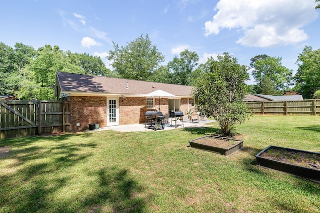 305 Forest Cir, Summerville, SC 29483 - rear view of property featuring a patio area, a vegetable garden, and brick siding