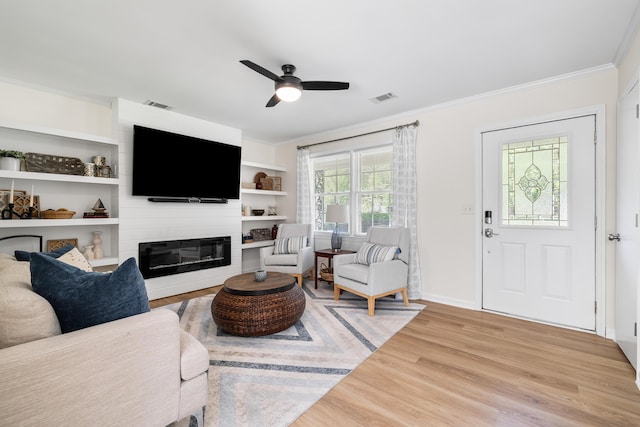305 Forest Cir, Summerville, SC 29483 - living room featuring wood finished floors, crown molding, ceiling fan, a large fireplace, and baseboards