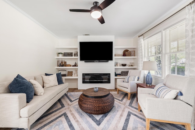 305 Forest Cir, Summerville, SC 29483 - living area featuring crown molding, ceiling fan, wood finished floors, and a glass covered fireplace