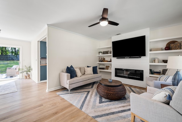 305 Forest Cir, Summerville, SC 29483 - living area with ornamental molding, light wood finished floors, ceiling fan, a large fireplace, and baseboards