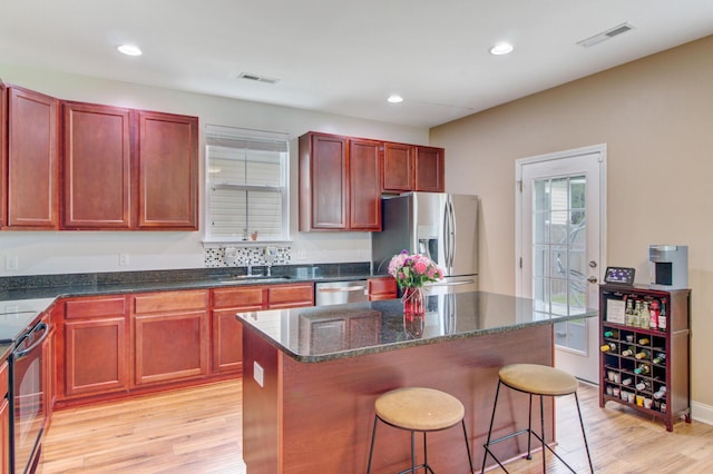 520 Crossland Dr, Moncks Corner, SC 29461 - kitchen with stainless steel appliances, a sink, dark brown cabinets, light wood-style flooring, and recessed lighting
