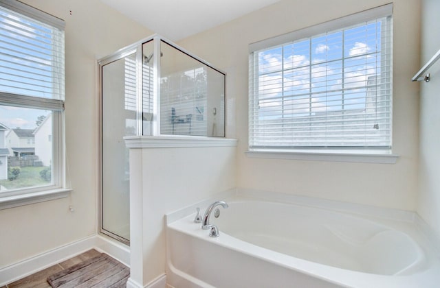 520 Crossland Dr, Moncks Corner, SC 29461 - full bathroom featuring a bath, a shower stall, wood finished floors, and baseboards