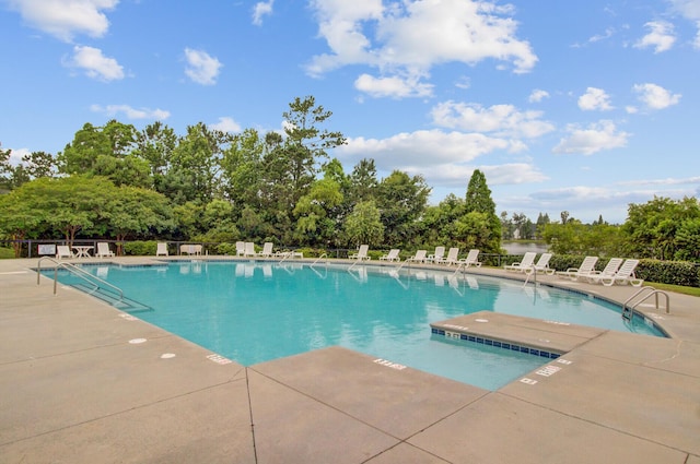 520 Crossland Dr, Moncks Corner, SC 29461 - community pool featuring a patio and view of wooded area