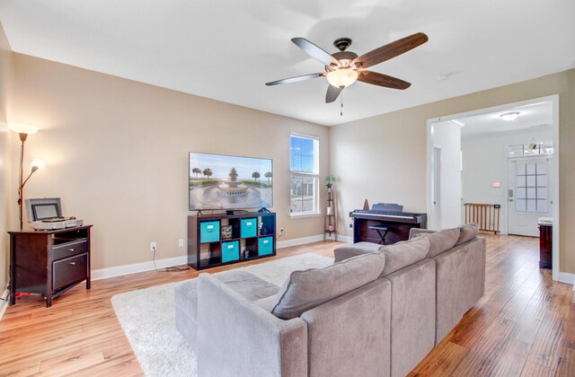 520 Crossland Dr, Moncks Corner, SC 29461 - living room with light wood-style flooring, a ceiling fan, and baseboards