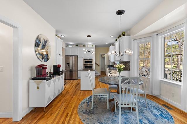 dining area featuring recessed lighting, visible vents, a chandelier, light wood-type flooring, and baseboards