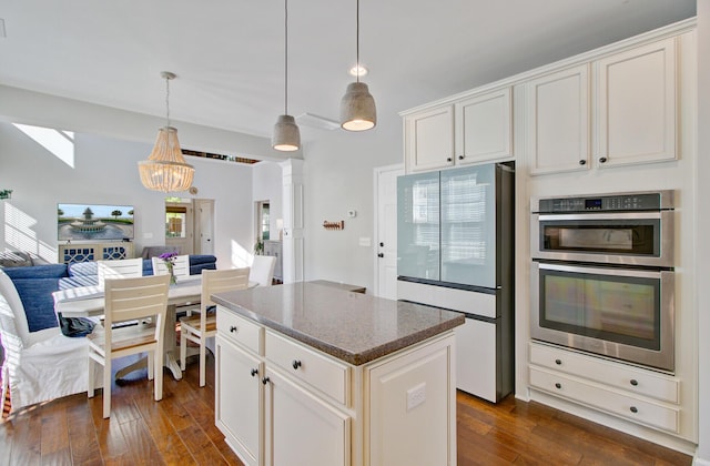 kitchen featuring refrigerator with glass door, stainless steel double oven, dark wood-style flooring, and a chandelier