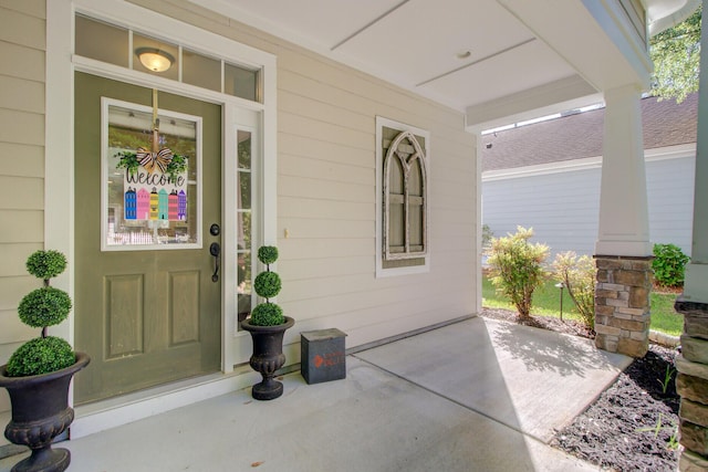 view of exterior entry with covered porch
