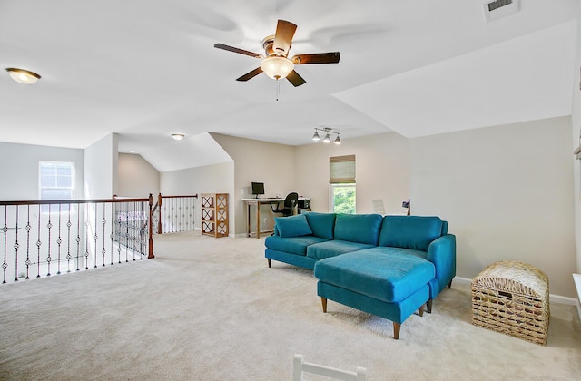 carpeted living room with baseboards, a ceiling fan, and visible vents