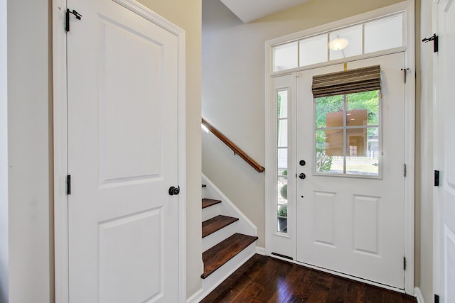 foyer with dark wood-style flooring and stairway
