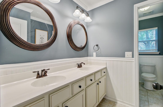 full bathroom with double vanity, a sink, wainscoting, and ornamental molding