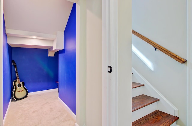 stairway with carpet floors and baseboards
