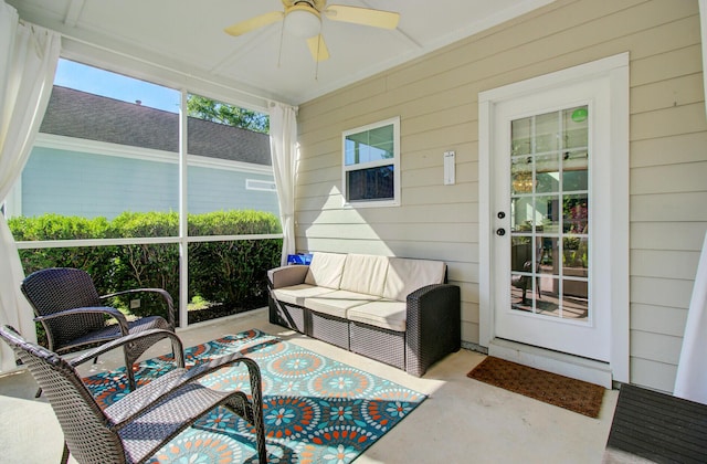 sunroom with ceiling fan and an outdoor living space