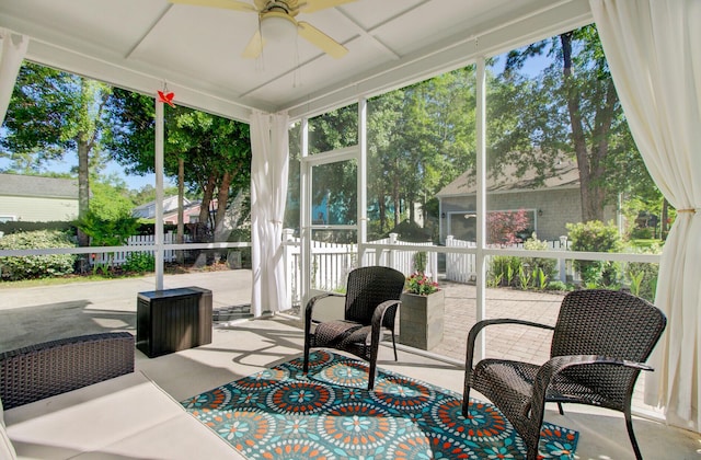sunroom / solarium featuring ceiling fan and a healthy amount of sunlight