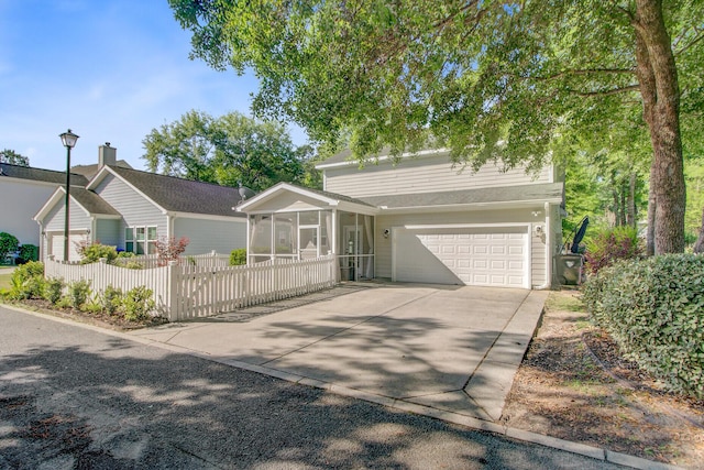 single story home featuring fence, driveway, and a sunroom