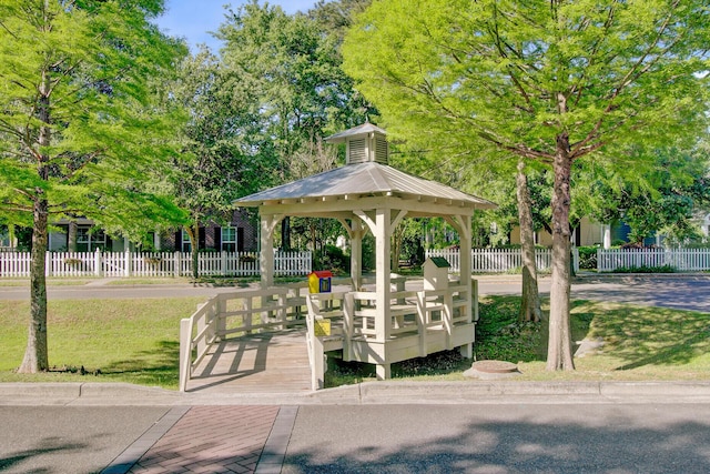 view of property's community with a gazebo and fence