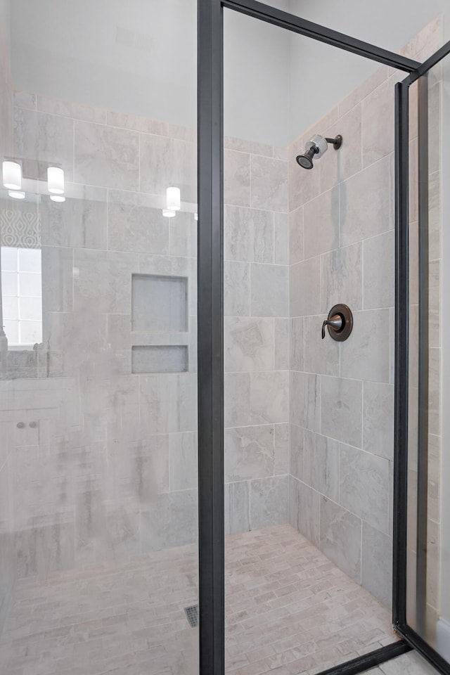 bathroom featuring a shower with shower door