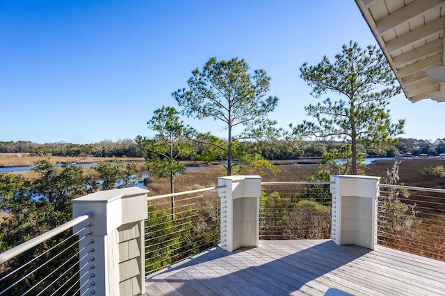 wooden terrace featuring a water view