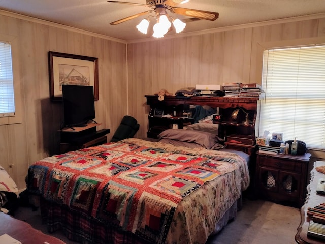 bedroom featuring ceiling fan, wooden walls, and ornamental molding