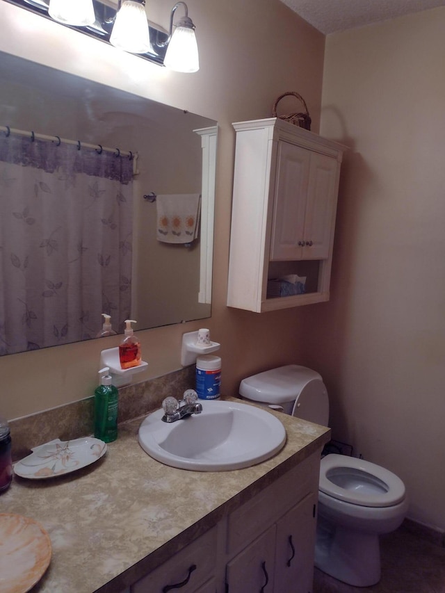 full bathroom featuring toilet, vanity, and a shower with curtain