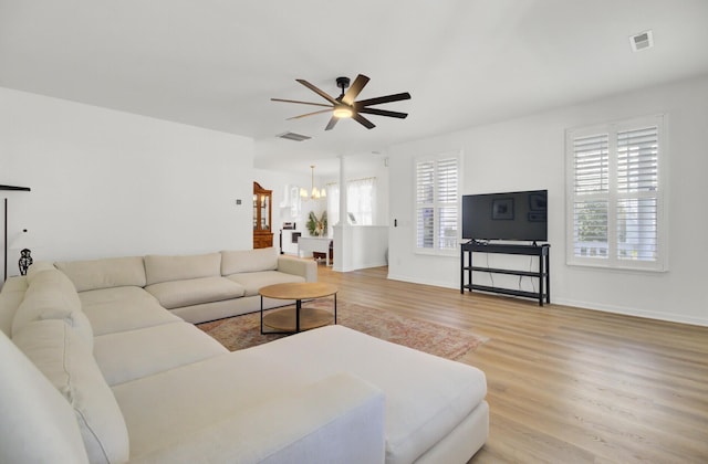 117 Red Leaf Blvd, Moncks Corner, SC 29461 - living room featuring a ceiling fan, light wood-type flooring, a chandelier, and baseboards