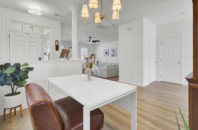 117 Red Leaf Blvd, Moncks Corner, SC 29461 - kitchen with a chandelier, light wood-style flooring, decorative columns, decorative light fixtures, and baseboards