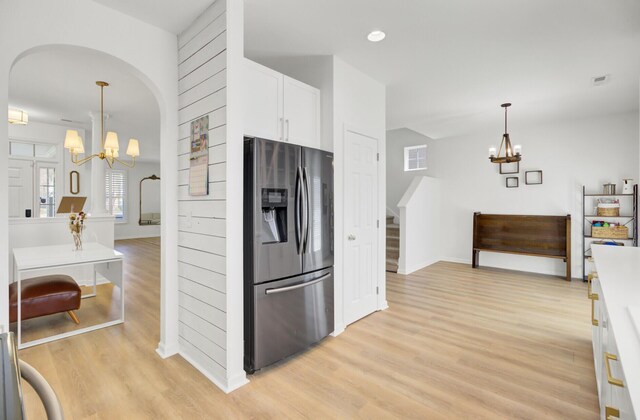 117 Red Leaf Blvd, Moncks Corner, SC 29461 - kitchen featuring stainless steel fridge with ice dispenser, a chandelier, light wood-style floors, and arched walkways