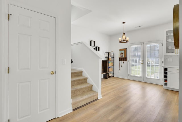 117 Red Leaf Blvd, Moncks Corner, SC 29461 - entryway with stairs, light wood-type flooring, a chandelier, and baseboards