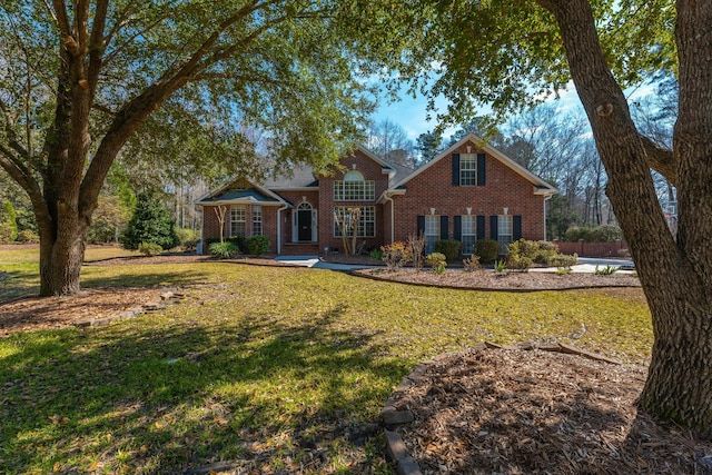 view of front of home with brick siding and a front lawn