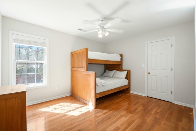 unfurnished bedroom with light wood-style floors, baseboards, visible vents, and a ceiling fan