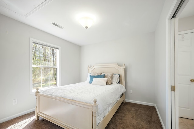 bedroom featuring attic access, carpet, visible vents, and baseboards