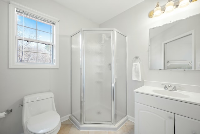 bathroom featuring tile patterned flooring, a shower stall, toilet, and vanity