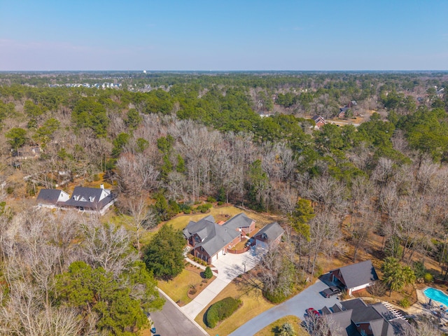 birds eye view of property with a wooded view