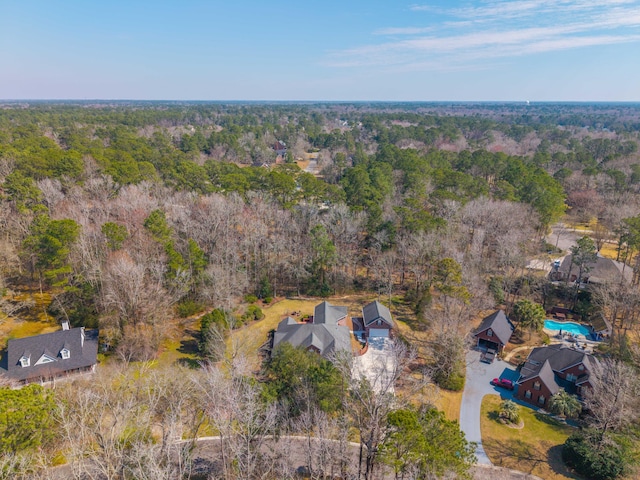 birds eye view of property with a forest view