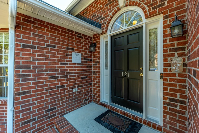 property entrance featuring brick siding