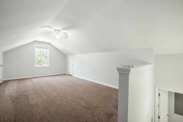 additional living space featuring vaulted ceiling, carpet, a ceiling fan, and baseboards