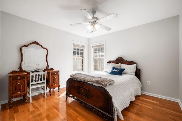 bedroom featuring light wood-style floors, ceiling fan, and baseboards