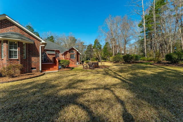 view of yard with a fire pit and a deck