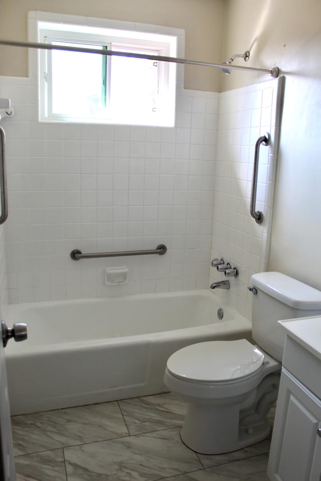 full bathroom with vanity, toilet, and tiled shower / bath