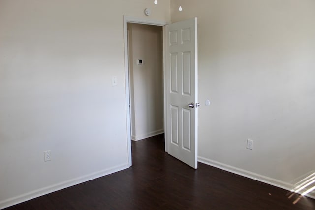 empty room featuring dark hardwood / wood-style flooring