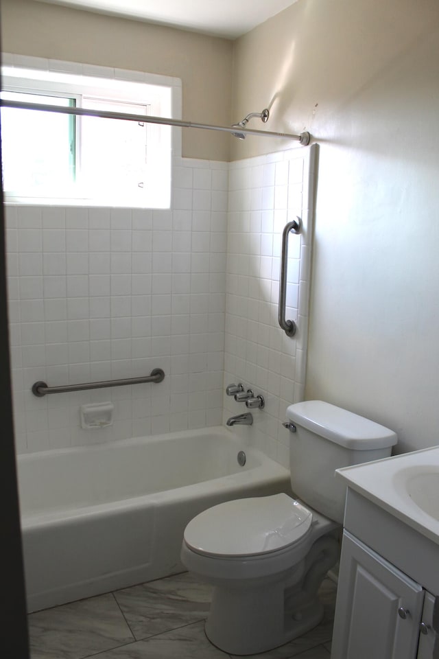 full bathroom with vanity, tiled shower / bath combo, and toilet