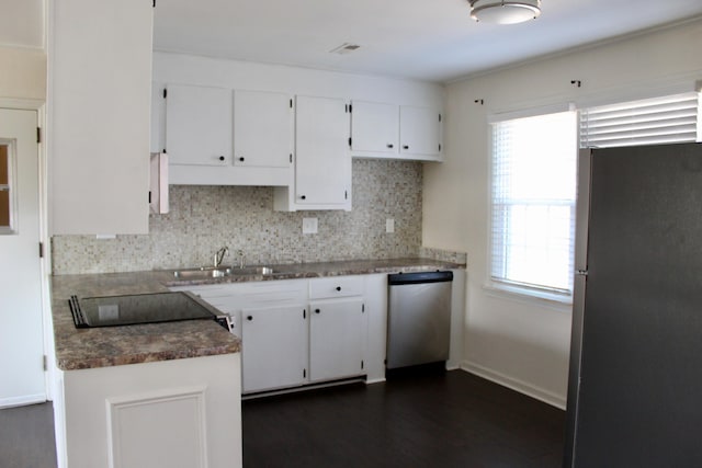 kitchen with backsplash, stainless steel appliances, sink, and white cabinets