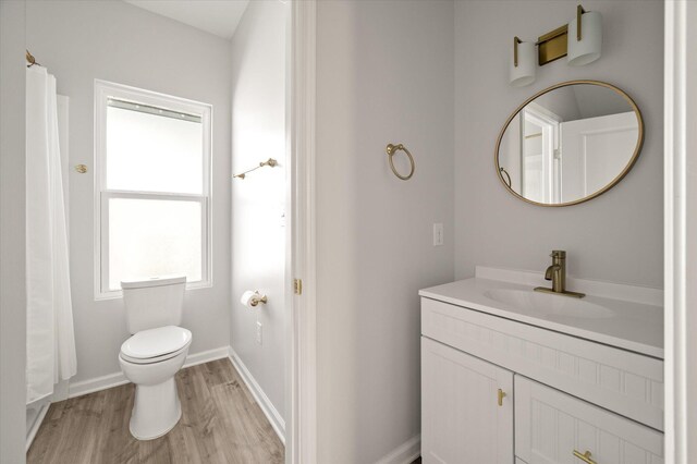 5748 Pilgrim Ave Unit D, Hanahan, SC 29410 - full bath with vanity, wood finished floors, toilet, baseboards, and a shower with shower curtain